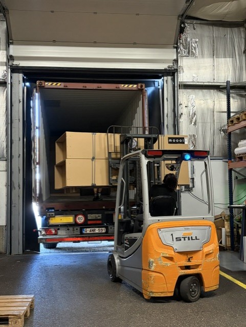 Vorkheftruck laadt dozen in een vrachtwagen via het laaddok